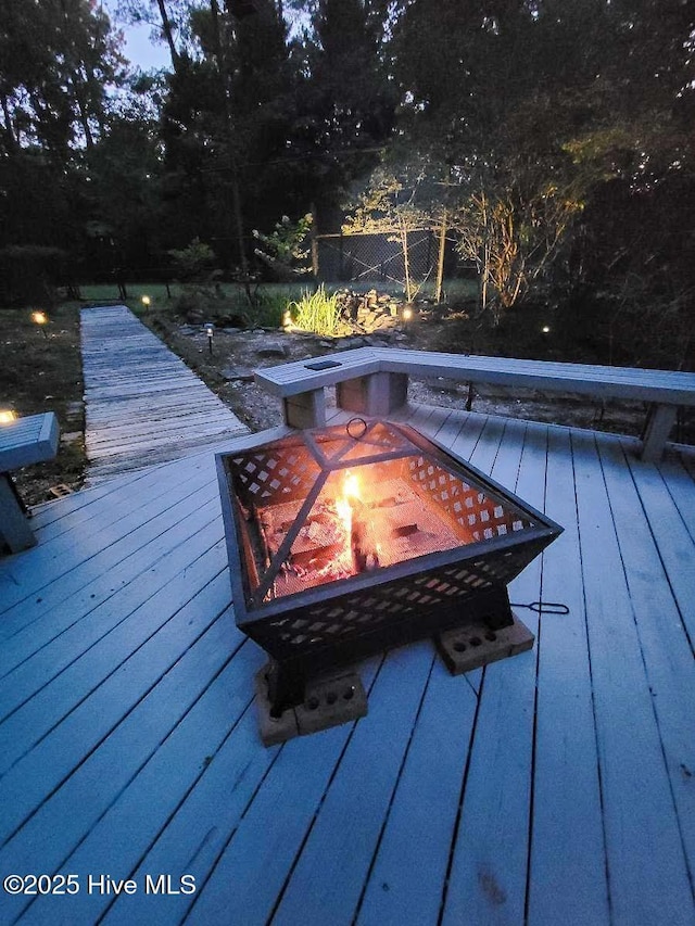 wooden terrace with a fire pit