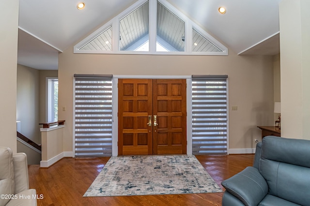 foyer entrance with lofted ceiling and wood-type flooring