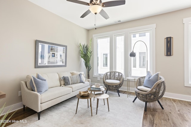 living room with ceiling fan and light hardwood / wood-style flooring