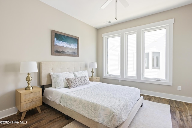 bedroom with ceiling fan and dark hardwood / wood-style flooring