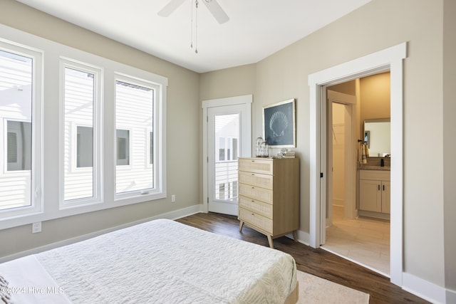 bedroom with ensuite bath, dark wood-type flooring, and ceiling fan