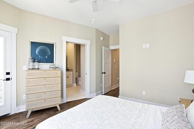 bedroom with dark hardwood / wood-style flooring, connected bathroom, and ceiling fan