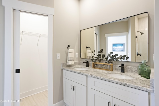 bathroom featuring vanity and a shower