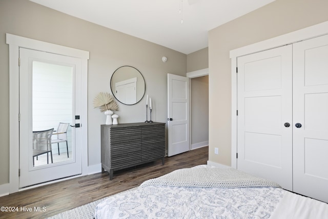 bedroom with dark hardwood / wood-style flooring and a closet