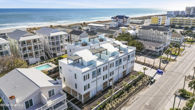 bird's eye view featuring a water view and a beach view