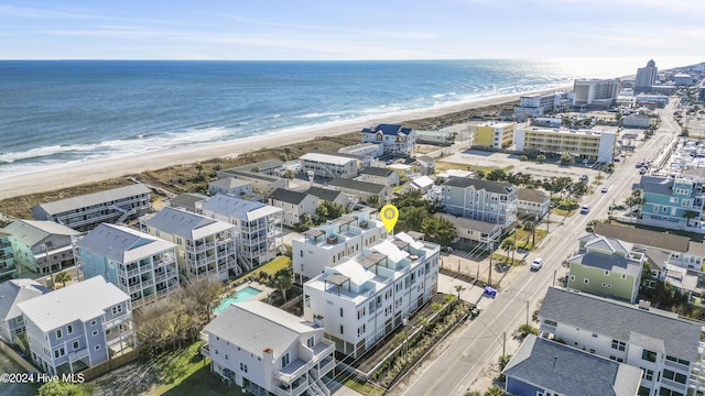 birds eye view of property with a water view and a view of the beach