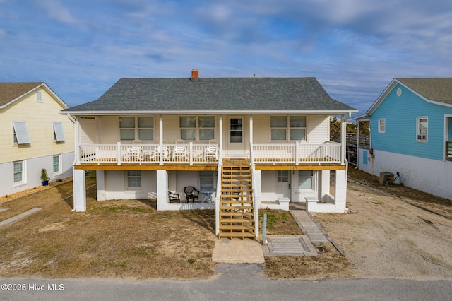 view of front of property with a porch and central air condition unit