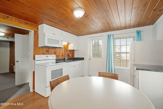 kitchen with sink, white appliances, white cabinetry, light hardwood / wood-style floors, and wooden ceiling