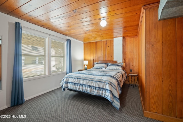 bedroom with carpet, wooden ceiling, and wooden walls