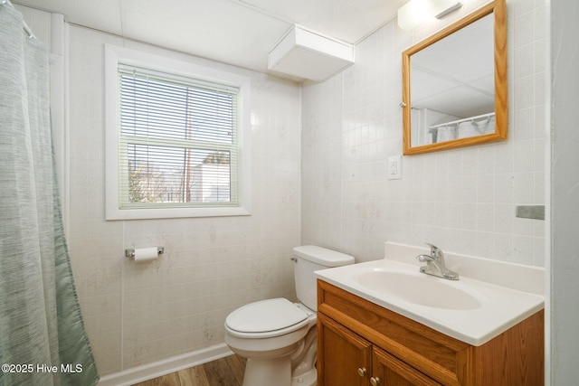 bathroom featuring vanity, hardwood / wood-style flooring, and toilet