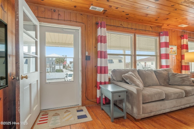 doorway featuring hardwood / wood-style floors, wooden walls, and wooden ceiling