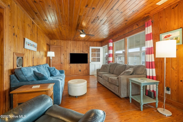 living room with ceiling fan, wooden walls, hardwood / wood-style floors, and wood ceiling