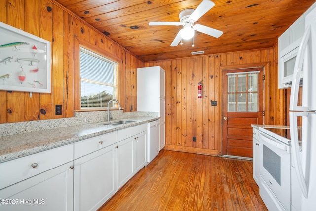 kitchen with sink, white appliances, white cabinetry, light stone countertops, and wooden ceiling