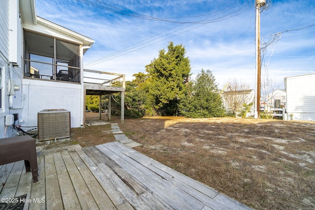 deck with central AC unit and a sunroom