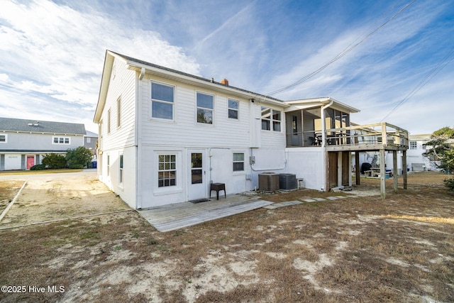 back of property featuring central AC unit and a wooden deck