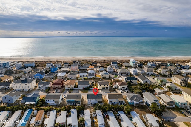 drone / aerial view with a water view and a view of the beach