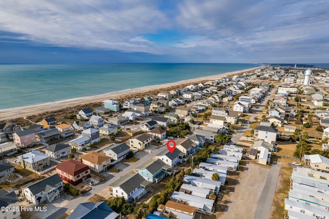 bird's eye view with a water view and a beach view