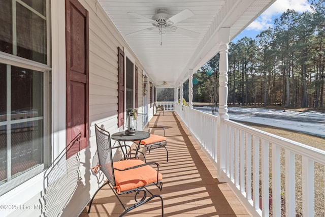 deck with ceiling fan and covered porch