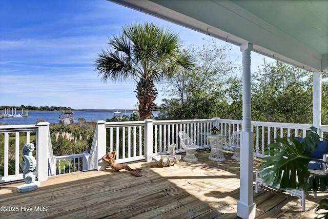 wooden deck featuring a water view