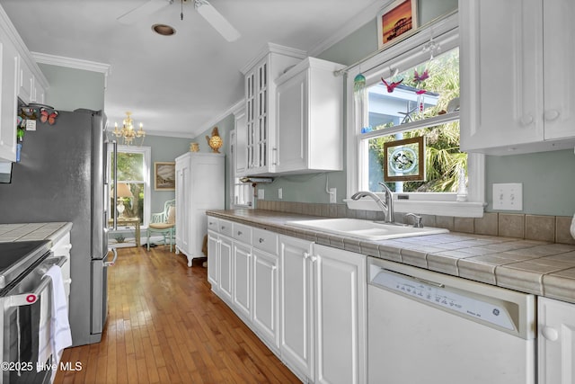 kitchen featuring white cabinetry, tile countertops, range, and white dishwasher