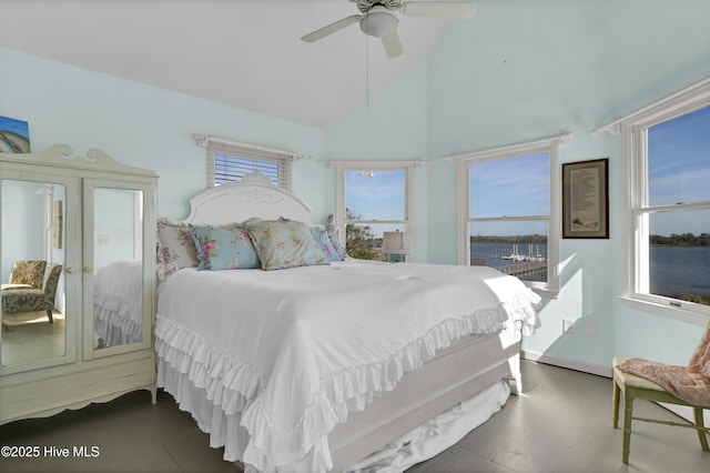 bedroom with ceiling fan and high vaulted ceiling