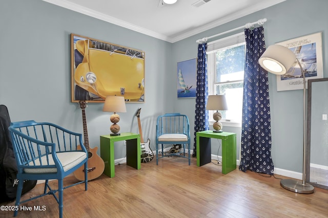 living area featuring ornamental molding and wood-type flooring