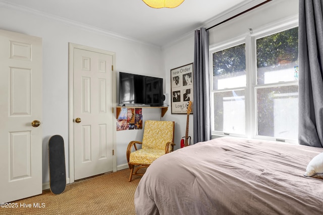 bedroom with crown molding and light carpet