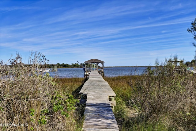 view of dock featuring a gazebo and a water view