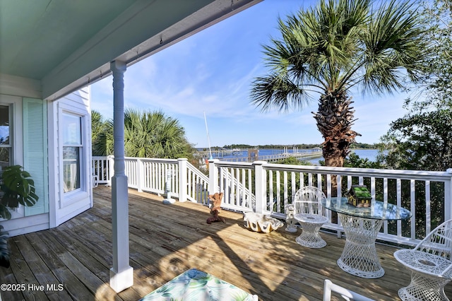 wooden terrace featuring a water view