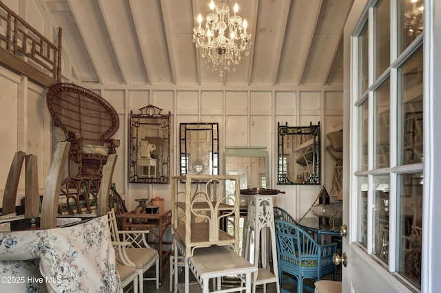 interior space featuring lofted ceiling and a chandelier