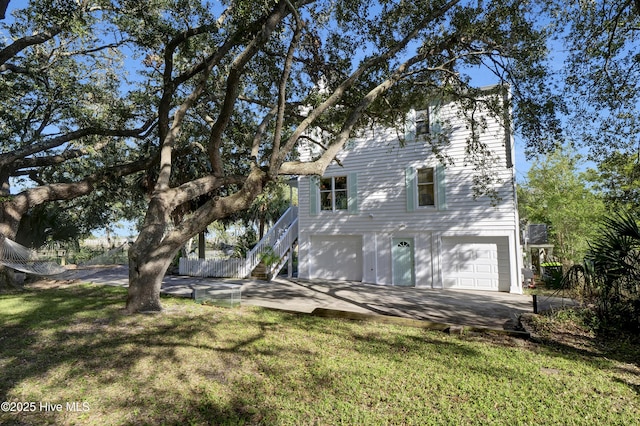 view of front of house with a garage and a front yard