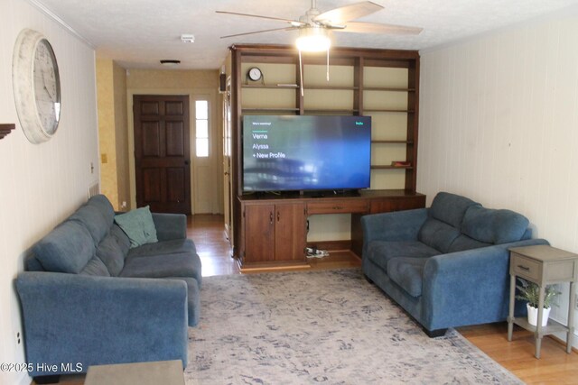 living room with ceiling fan and light hardwood / wood-style flooring