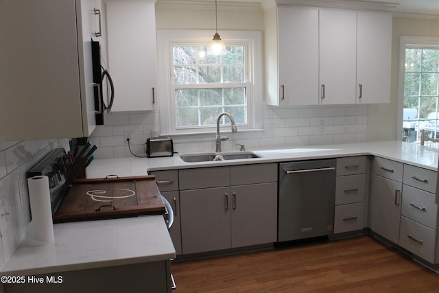 kitchen with pendant lighting, sink, gray cabinetry, tasteful backsplash, and stainless steel dishwasher