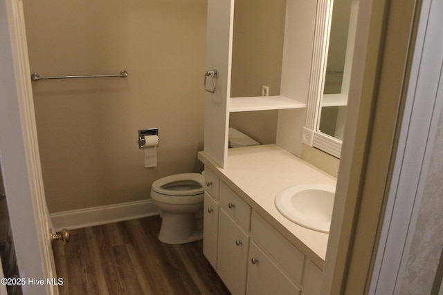 bathroom featuring vanity, hardwood / wood-style floors, and toilet