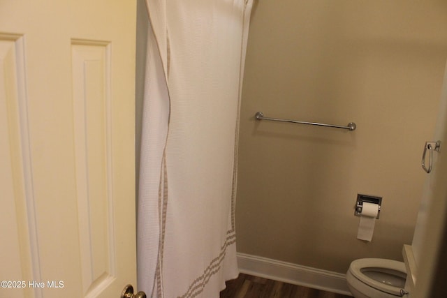 bathroom featuring hardwood / wood-style floors and toilet