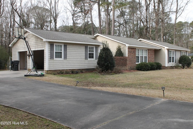 view of front of home with a garage and a front lawn