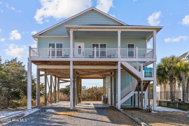 coastal home featuring a carport and covered porch