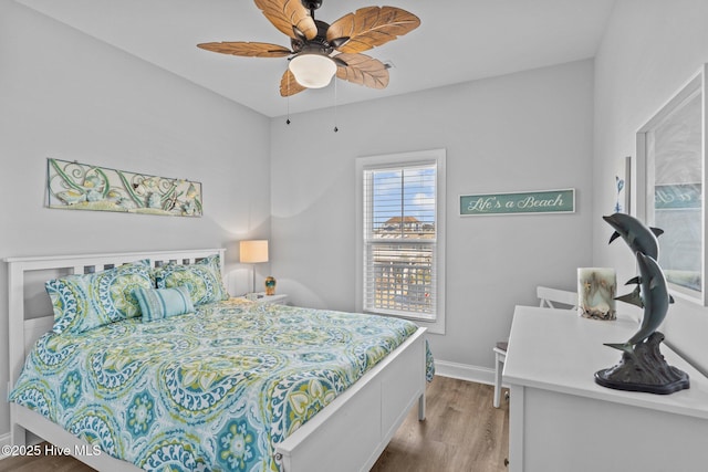 bedroom with light hardwood / wood-style flooring and ceiling fan