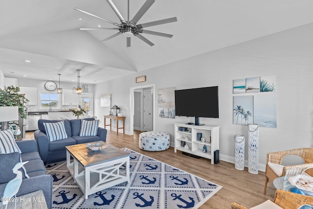 living room with vaulted ceiling, light hardwood / wood-style floors, and ceiling fan