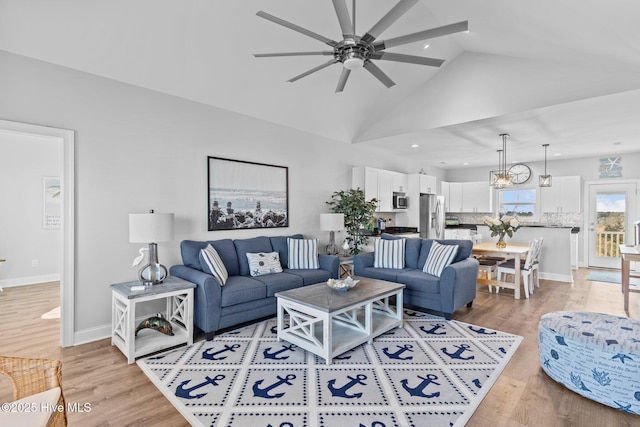 living room featuring ceiling fan, high vaulted ceiling, and light hardwood / wood-style floors