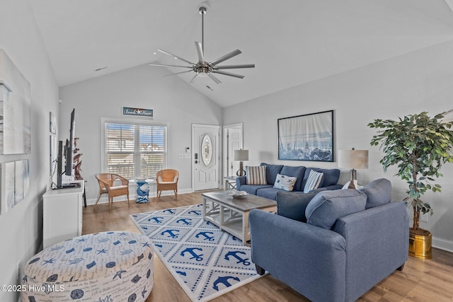 living room featuring hardwood / wood-style flooring, high vaulted ceiling, and ceiling fan