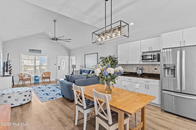 kitchen with appliances with stainless steel finishes, tasteful backsplash, white cabinets, ceiling fan, and light wood-type flooring