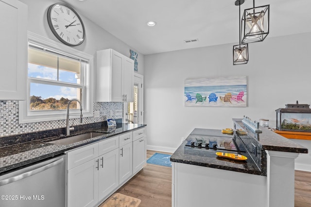 kitchen featuring sink, white cabinets, and dishwasher