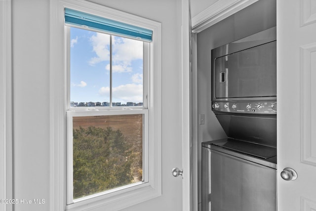 laundry area featuring stacked washer and clothes dryer