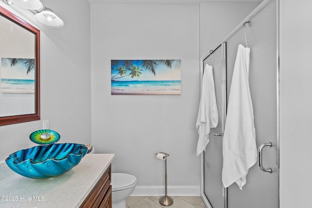 bathroom with vanity, tile patterned floors, toilet, and walk in shower