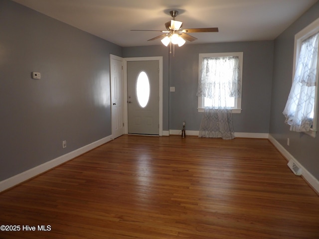 foyer with dark wood-type flooring and ceiling fan