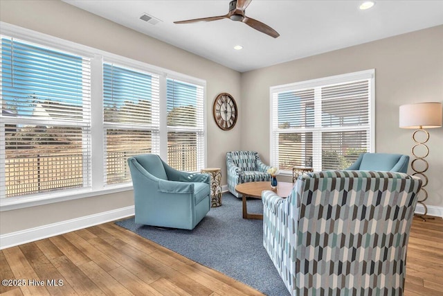 living room featuring hardwood / wood-style flooring and ceiling fan