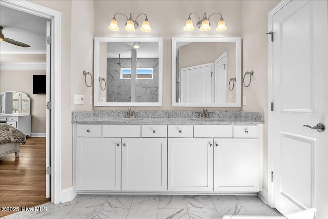 bathroom featuring ornamental molding, an enclosed shower, ceiling fan, and vanity