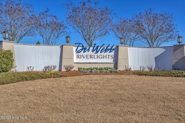 community / neighborhood sign with a lawn