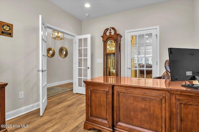 office area with light hardwood / wood-style flooring and french doors